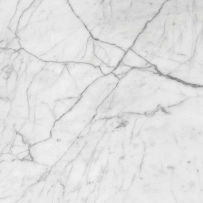 Close view of grey veining across white Bianco Carrara marble