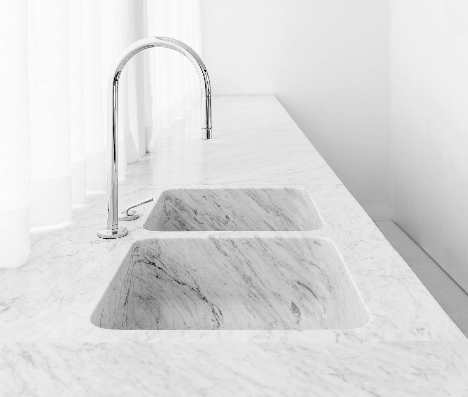 White and grey marble benchtop with an integrated double sink and chrome tap